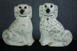A large matching pair of Staffordshire dogs. No makers mark. H.34cm. Hand decorated and finished