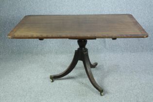 Breakfast or dining table, Regency mahogany and crossbanded with tilt top action. H.71 L.137 W.89cm.