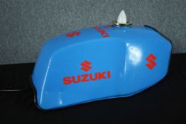 An original Suzuki motorcycle petrol tank converted into a lamp. H.30 W.58 D.30cm.