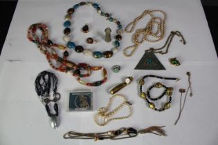 A collection of jewellery, including a frog and snail brooch, a Tibetan agate bead necklace, a