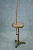 An unusual tribal style carved hardwood stand fitted with sliding drawers and adjustable pole. H.