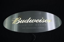 An illuminated Budweiser sign. 'King of Beers'. H.56 W.20 cm.