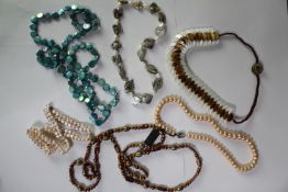 A collection of six mixed cultured pearl necklaces, including a dyed blue circular fresh water pearl