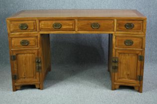 Pedestal desk, Chinese elm of curved outline, in three sections. H.85 W.150 D.66cm.