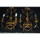 A pair of gilt metal and gesso wall mounted candelabras. L.64cm. (each)