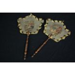 Two early 19th century embroidered floral hand held face screens with turned wooden handles. H.42