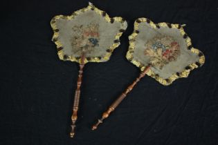 Two early 19th century embroidered floral hand held face screens with turned wooden handles. H.42
