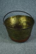A large Victorian brass pot with a copper base and iron rim and handle. H.32 Dia. 50 cm.