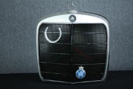 An original Mercedes car grille. Illuminated and mounted on a panel and decorated with a
