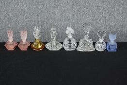 A collection of eight Art Deco and late 20th century coloured and clear glass perfume bottles,