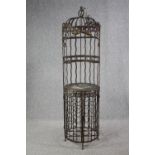 A large vintage wrought iron wine rack with a decorative birdcage attached. H.186 Dia. 50cm.