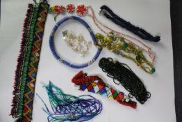 A collection of African tribal coloured seed bead jewellery, including a multi coloured zig zag
