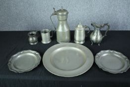 A collection of pewter items, including a charger, a matching pair of plates, a cup and jugs. Dia.