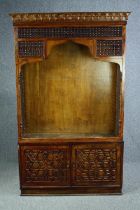 Bookcase cabinet, carved hardwood of North African influence, in two sections. H.200 W.123 D.34cm.