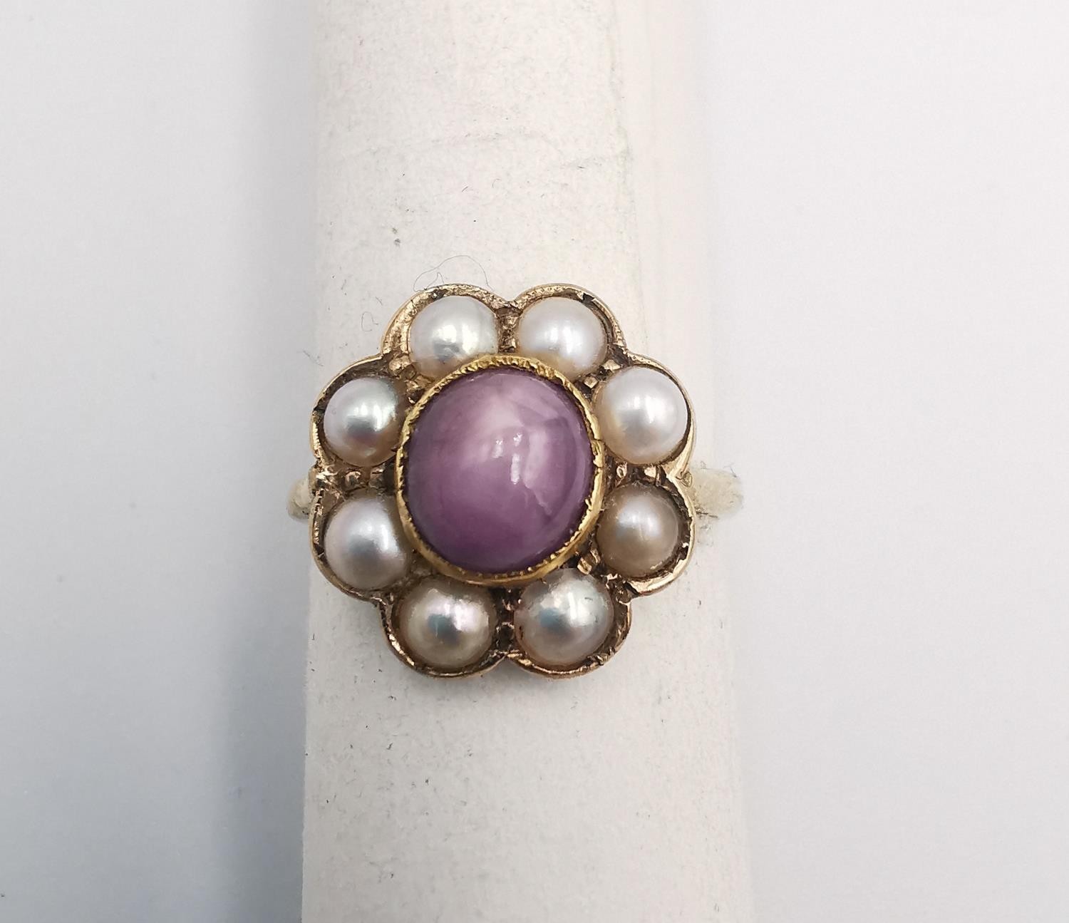A Victorian Star ruby and cultured pearl and yellow metal (tests higher than 9ct) cluster ring.