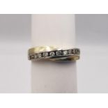 A 14 carat yellow and white gold diamond set twist half eternity ring. Set with ten round