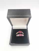 Two ruby set rings, a silver three stone ruby ring and a ruby and diamond 9ct white gold flanked