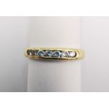 An 18ct yellow gold diamond seven stone half eternity style ring. Set with seven round brilliant cut