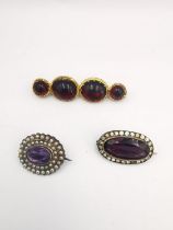 A red paste foil backed rolled gold brooch, along with a purple paste silver cluster brooch and an