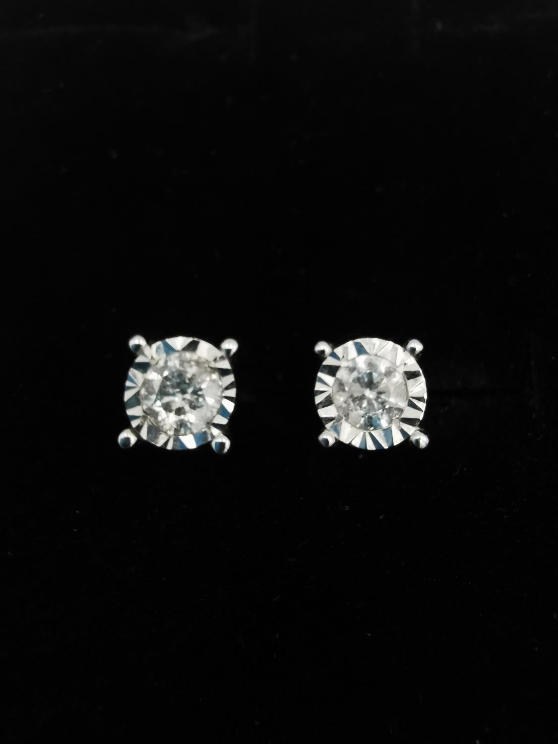 A pair of 18ct white gold and diamond stud earrings, each earrings set with a round brilliant cut