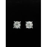 A pair of 18ct white gold and diamond stud earrings, each earrings set with a round brilliant cut