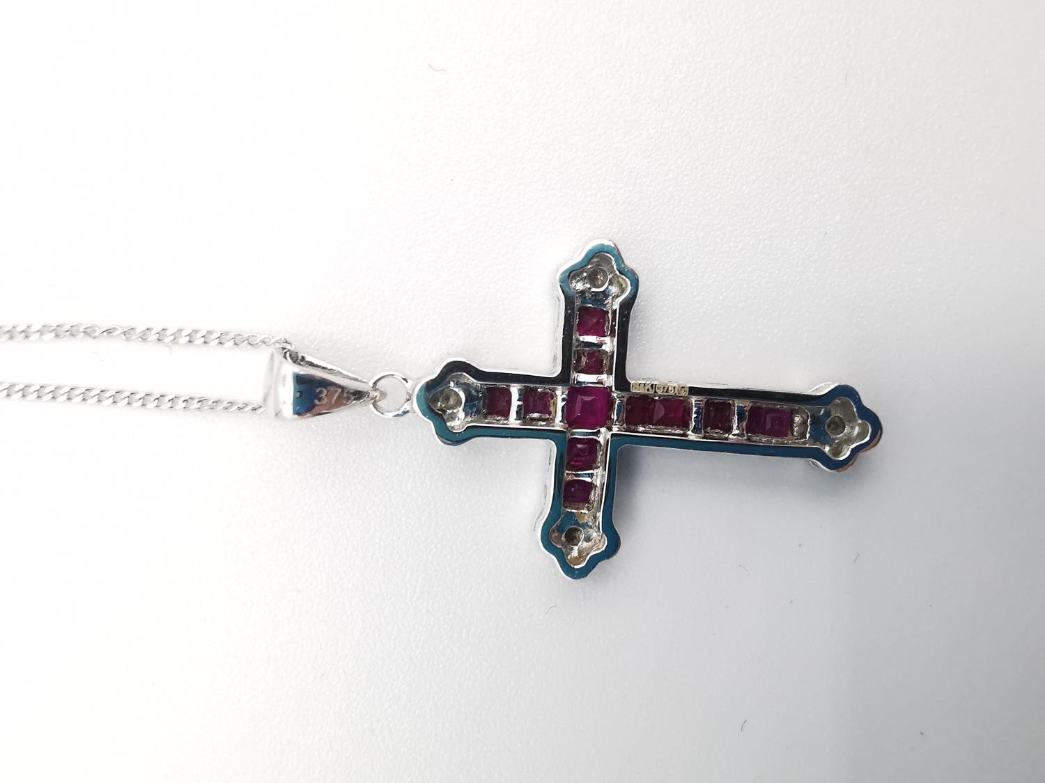 A boxed 9ct white gold ruby and diamond cross and chain. The cross set with twelve square channel - Image 5 of 7