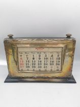 A sterling silver and ebony desk calendar, with removable cards and brass turning knobs. Hallmarked: