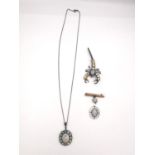 A collection of opal jewellery, including a black opal and white metal cluster pendant and chain,