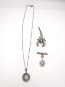 A collection of opal jewellery, including a black opal and white metal cluster pendant and chain,