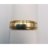 A 9ct wide yellow and white gold D-shape band. Hallmarked:375, Sheffield. Ring size T. Weight 4.7g