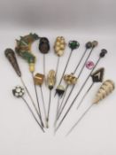 A collection of sixteen antique and vintage hat pins of various designs, one silver by Charles