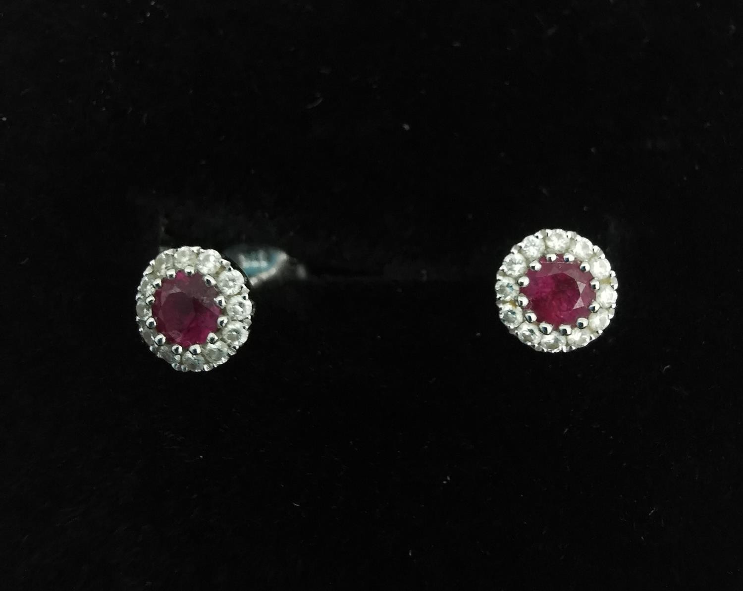 A pair of 18ct white gold ruby and diamond cluster stud earrings. Each set to centre with a round - Image 4 of 6