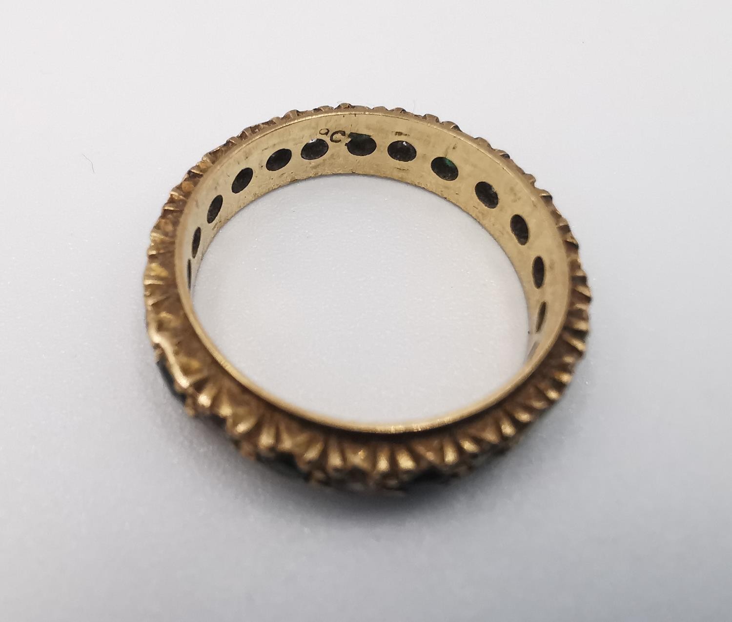 A 9ct yellow gold full eternity ring set with cubic zirconia and green paste stones. Stamped 9ct. - Image 4 of 4