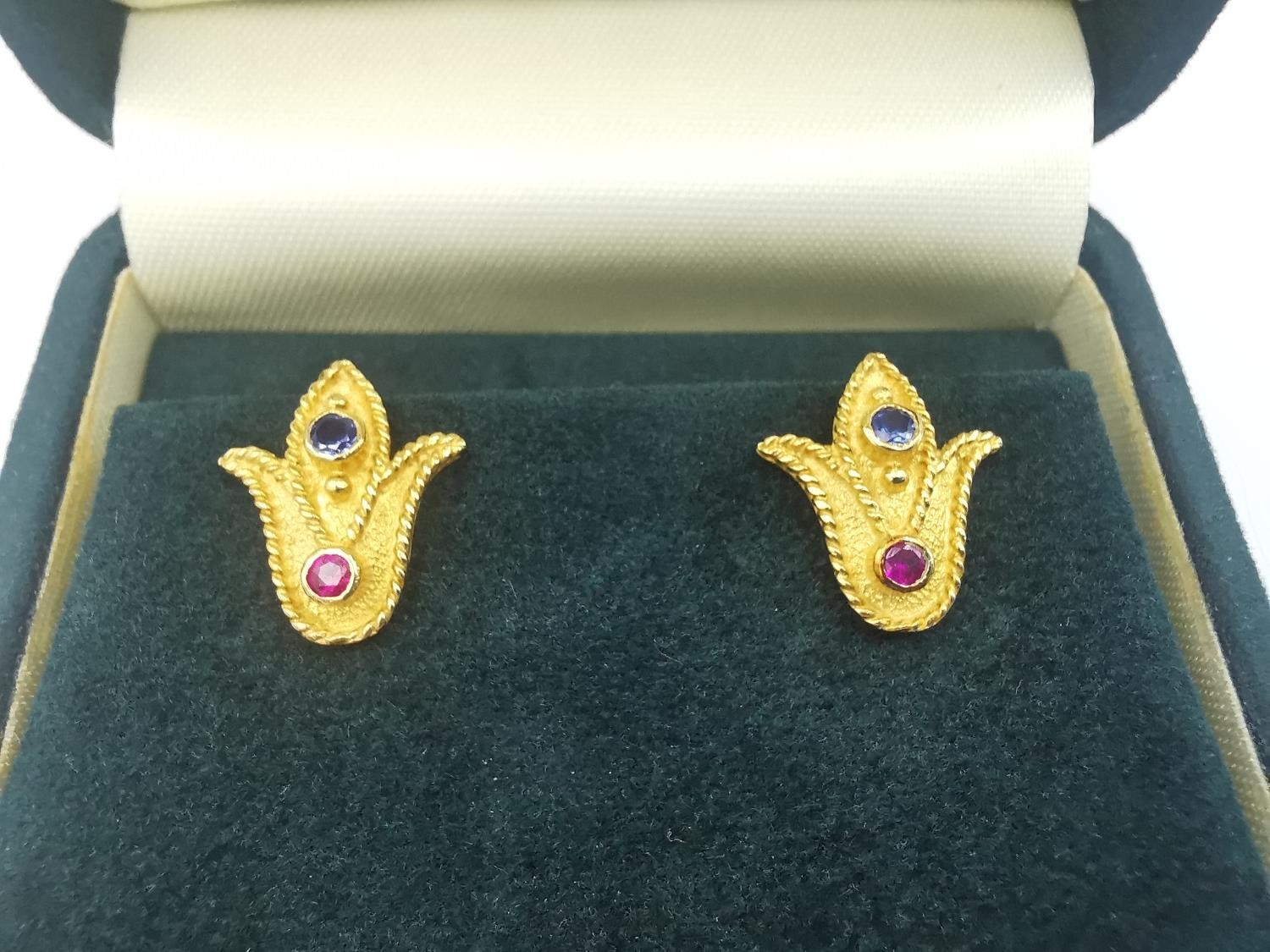 A boxed set of 18ct yellow gold ruby and sapphire stud earrings by Greek fine jewellers