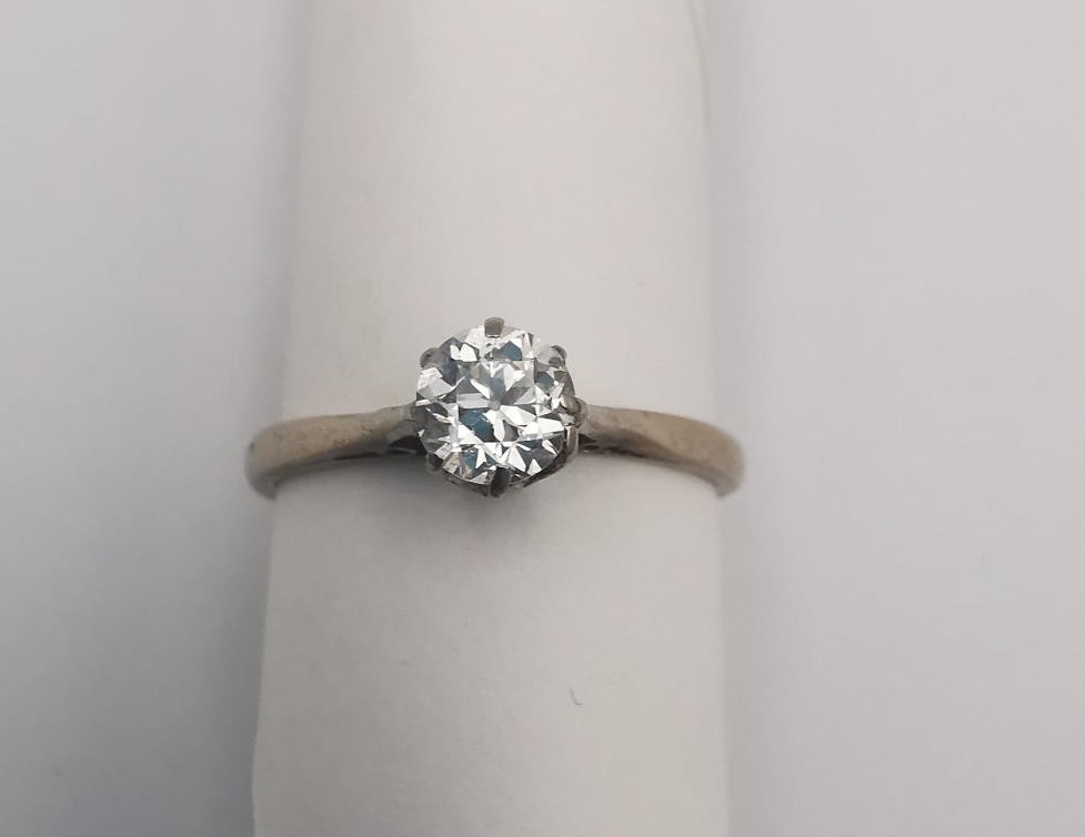 A boxed 18ct carat white gold diamond solitaire ring. The ring set with a round old cut diamond with