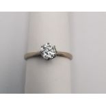 A boxed 18ct carat white gold diamond solitaire ring. The ring set with a round old cut diamond with