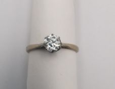A boxed 18ct carat white gold diamond solitaire ring. The ring set with a round old cut diamond with