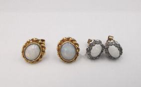 Two pairs of 9ct yellow gold opal stud earrings, one pair with oval opal cabochons in a rope twist