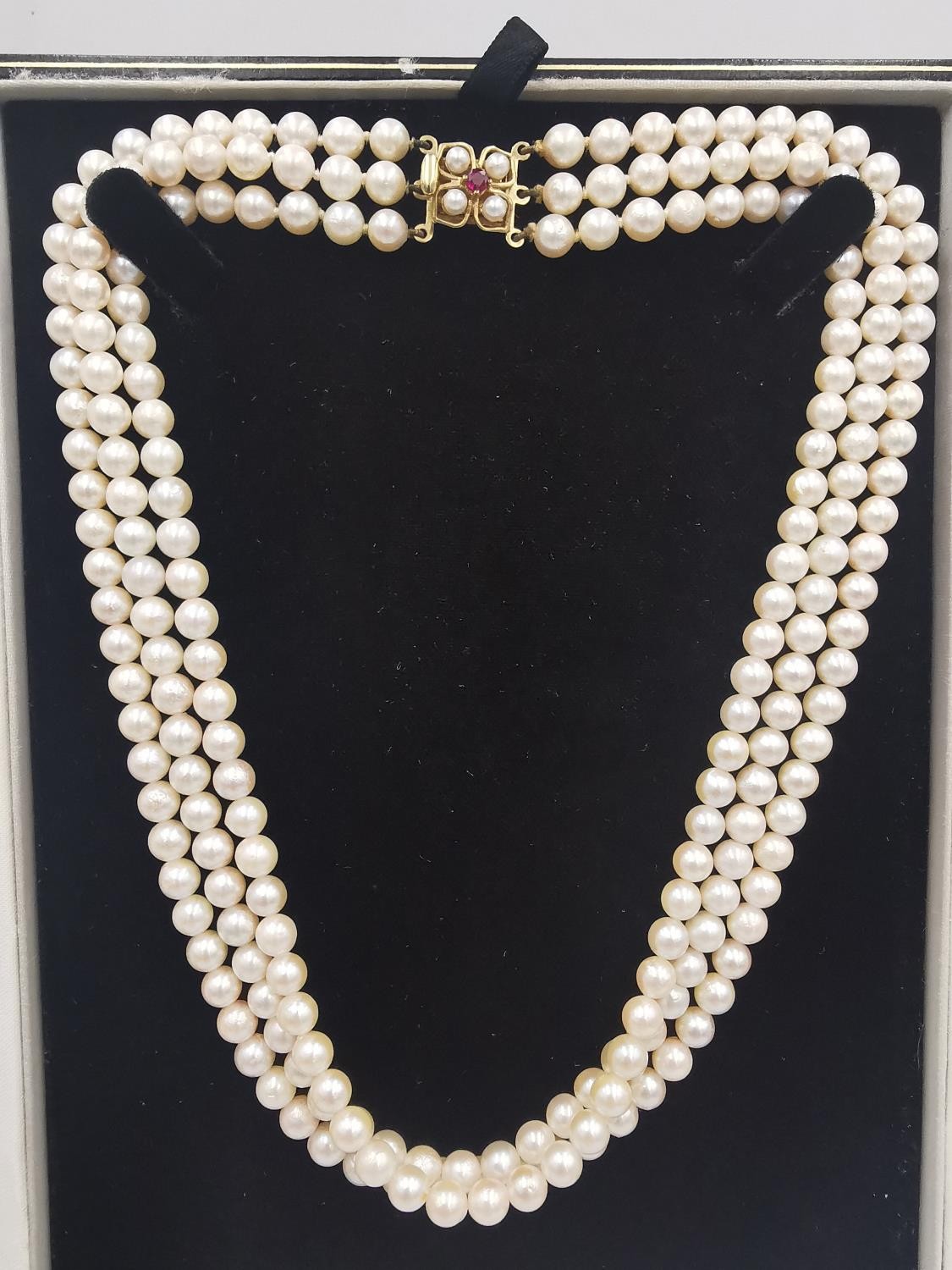 A vintage boxed knotted triple strand cultured pearl necklace with 9ct yellow gold, pearl and ruby