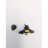 Jocelyn Burton, a leather boxed silver and enamel bumble bee pin with a honeycomb push back.