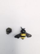 Jocelyn Burton, a leather boxed silver and enamel bumble bee pin with a honeycomb push back.