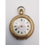 An Edwardian 14ct rose gold Swiss ladies fob watch with engraved design. The back case decorated