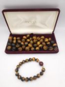A boxed vintage tigers eye bead necklace and matching bracelet. (Necklace is broken).