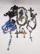 A collection of five early 20th century rosaries and a hardwood and brass crucifix, including a