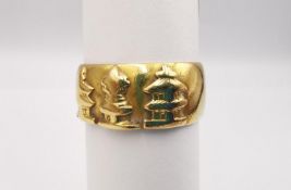 A yellow metal (tests as higher than 14ct) wide band with three relief Thai spirit house motifs.