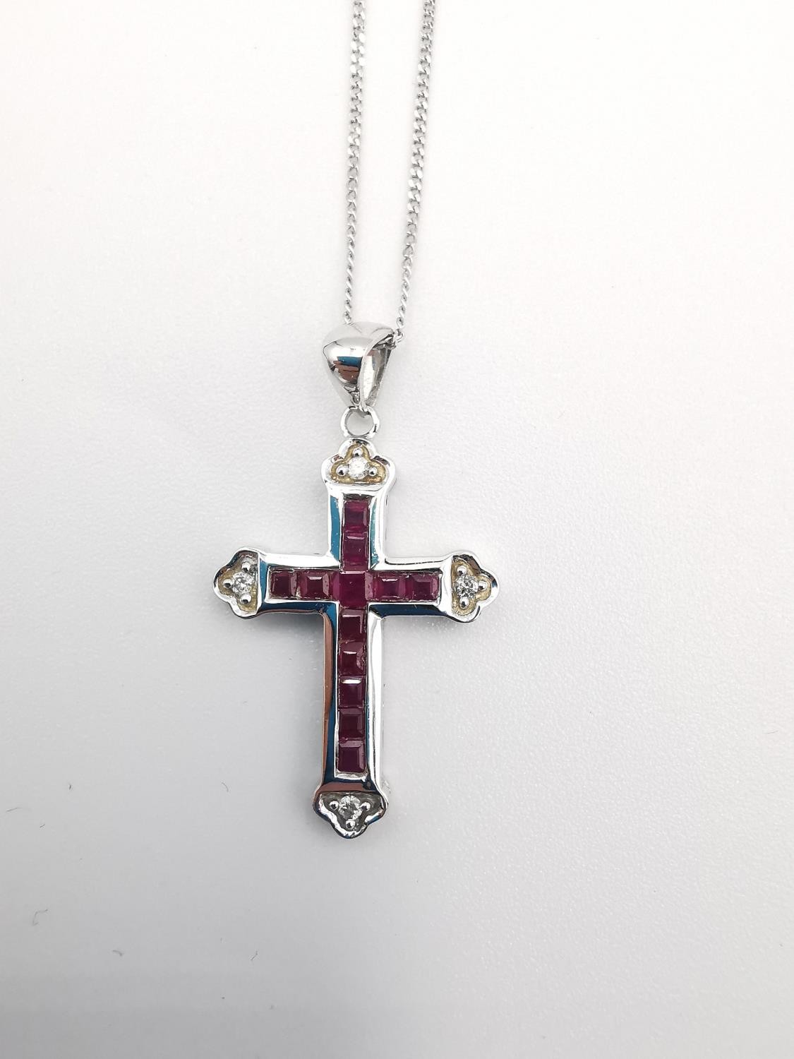 A boxed 9ct white gold ruby and diamond cross and chain. The cross set with twelve square channel - Image 4 of 7