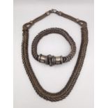 A traditional Indian silver spiral chain link rope necklace and matching bracelet. The bracelet