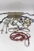 A collection of tribal jewellery, including two white metal (not silver) articulated bracelets,