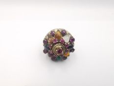 A 14 carat rose gold multi gemstone Harem Thai princess ring. Set with seventeen round mixed cut