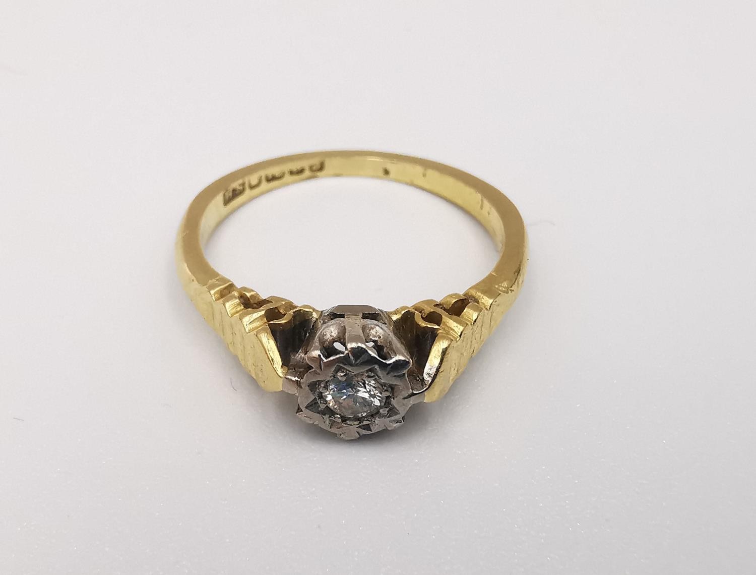 An 18ct yellow and white gold diamond solitaire ring. Set to centre with a round brilliant cut - Image 3 of 4